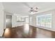 Open living room boasting hardwood floors, natural light, and direct view into the kitchen at 220 Drumcliff Ct, Tyrone, GA 30290