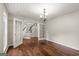 Living room featuring hardwood floors, natural light, and double french doors at 220 Drumcliff Ct, Tyrone, GA 30290