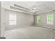 Spacious main bedroom features ceiling fan and natural light at 220 Drumcliff Ct, Tyrone, GA 30290