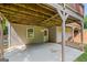 Covered outdoor patio with concrete flooring, wooden supports, and an exterior door and window for outdoor enjoyment at 220 Drumcliff Ct, Tyrone, GA 30290