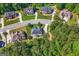 Aerial view showcases a community of homes surrounded by lush greenery at 130 Edgewater Trl, Fayetteville, GA 30215