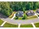 Stunning aerial view of the home with a large, green yard on a corner lot in a beautiful neighborhood at 130 Edgewater Trl, Fayetteville, GA 30215