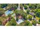 An aerial view shows community amenities nestled among lush landscaping and nearby houses and roads at 130 Edgewater Trl, Fayetteville, GA 30215