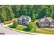 Aerial view of a beautiful home with lush landscaping and a well-manicured lawn at 130 Edgewater Trl, Fayetteville, GA 30215