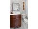 Powder room features a dark wood vanity, large mirror, and a white toilet at 130 Edgewater Trl, Fayetteville, GA 30215