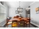 Elegant dining room featuring a large wooden table, decorative accents, and modern lighting at 130 Edgewater Trl, Fayetteville, GA 30215