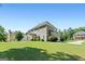 A view of the home's backyard, featuring a well-manicured lawn and ample space for outdoor activities at 130 Edgewater Trl, Fayetteville, GA 30215