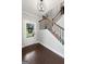 View of foyer boasting hardwood floors, staircase, and front door view of landscaped yard at 130 Edgewater Trl, Fayetteville, GA 30215