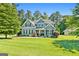 Charming two-story home featuring a well-manicured lawn, lush landscaping, and inviting front porch at 130 Edgewater Trl, Fayetteville, GA 30215