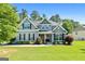 Inviting two-story home with a well-kept lawn, vibrant greenery, and a welcoming entrance at 130 Edgewater Trl, Fayetteville, GA 30215