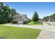 Attractive home exterior with a well-kept lawn, landscaping, and a long driveway at 130 Edgewater Trl, Fayetteville, GA 30215