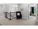 Upstairs hallway featuring a dark wood railing and neutral colors at 130 Edgewater Trl, Fayetteville, GA 30215