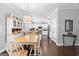 Bright eat-in kitchen featuring hardwood floors, white cabinetry, and stainless steel appliances at 130 Edgewater Trl, Fayetteville, GA 30215