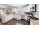 Spacious kitchen with white cabinets, granite countertops, stainless steel appliances, and hardwood floors at 130 Edgewater Trl, Fayetteville, GA 30215