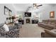 Bright living room featuring a fireplace, large TV, and plush couches at 130 Edgewater Trl, Fayetteville, GA 30215