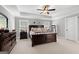 Spacious main bedroom featuring a tray ceiling, dark wood furniture, and carpeted floors at 130 Edgewater Trl, Fayetteville, GA 30215
