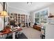 Bright office with a wall of built in bookshelves and a large window at 130 Edgewater Trl, Fayetteville, GA 30215