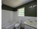 Bathroom view with white tiled walls, a toilet, sink, and bathtub requiring upgrades and renovations at 4274 Kimball Sw Rd, Atlanta, GA 30331