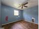 Bedroom featuring hardwood floors, a ceiling fan, and peeling blue paint. Ready for remodeling at 4274 Kimball Sw Rd, Atlanta, GA 30331