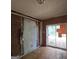Shows a bedroom with damaged walls, old tile floors, and a sliding door to the outside at 4274 Kimball Sw Rd, Atlanta, GA 30331
