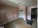Bedroom featuring older linoleum floors, peeling pink paint, and closet awaiting renovation at 4274 Kimball Sw Rd, Atlanta, GA 30331