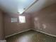 Bedroom featuring older linoleum floors and peeling pink paint, ready for remodeling and updates at 4274 Kimball Sw Rd, Atlanta, GA 30331