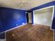 Bedroom featuring hardwood floors, a closet, and dark blue painted walls awaiting remodel at 4274 Kimball Sw Rd, Atlanta, GA 30331