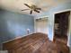Bedroom featuring hardwood floors, a closet, and peeling blue paint awaiting renovation at 4274 Kimball Sw Rd, Atlanta, GA 30331
