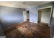 Bedroom featuring hardwood floors, peeling blue paint, and closet awaiting renovation at 4274 Kimball Sw Rd, Atlanta, GA 30331