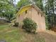 Side view of a two-story brick home with yellow accents and mature trees at 4274 Kimball Sw Rd, Atlanta, GA 30331