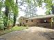 View of the rear of the home with a carport, brick exterior, and a sloped backyard at 4274 Kimball Sw Rd, Atlanta, GA 30331