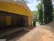 Attached garage with a yellow door and space for parking, along with a paved driveway at 4274 Kimball Sw Rd, Atlanta, GA 30331