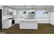Bright modern kitchen with white cabinets, stone countertops, stainless appliances, and stylish pendant lighting at 4274 Kimball Sw Rd, Atlanta, GA 30331
