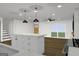 Bright kitchen with white cabinets, stone countertops, stainless appliances, stylish pendant lighting, and hardwood floor at 4274 Kimball Sw Rd, Atlanta, GA 30331