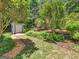 The backyard features a storage shed, gravel paths, and mature landscaping, offering practical storage and natural beauty at 264 Keller Dr, Mcdonough, GA 30252