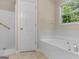 Bathroom with separate shower and soaking tub and a large window at 264 Keller Dr, Mcdonough, GA 30252