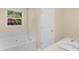 Bright bathroom with a large soaking tub and neutral décor at 264 Keller Dr, Mcdonough, GA 30252