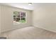 Bright bedroom featuring neutral carpet and walls and a window view of lush backyard greenery at 264 Keller Dr, Mcdonough, GA 30252