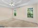 Bedroom features large windows with outdoor view and a ceiling fan at 264 Keller Dr, Mcdonough, GA 30252