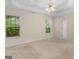 Bedroom showcasing natural light and a tray ceiling with fan at 264 Keller Dr, Mcdonough, GA 30252