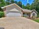 Traditional home with a driveway leading to an attached two car garage at 264 Keller Dr, Mcdonough, GA 30252