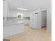 Bright eat-in kitchen features white cabinetry, countertops, and a stainless steel sink under a window at 264 Keller Dr, Mcdonough, GA 30252
