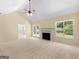 Inviting living room featuring a fireplace, ceiling fan and outdoor views at 264 Keller Dr, Mcdonough, GA 30252