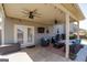 Relaxing covered back porch with ceiling fans, outdoor seating, and a grill at 7435 Ansley Park Way, Cumming, GA 30028