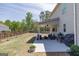 Spacious backyard featuring a covered patio with comfortable seating and a grill at 7435 Ansley Park Way, Cumming, GA 30028