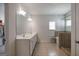 Bright bathroom with dual vanity, tile flooring, and a glass-enclosed shower, creating a spa-like experience at 7435 Ansley Park Way, Cumming, GA 30028