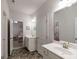 Bright bathroom with double sink vanity, tile floor, and shower at 7435 Ansley Park Way, Cumming, GA 30028