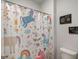 Cute bathroom with unicorn-themed shower curtain and colorful decor at 7435 Ansley Park Way, Cumming, GA 30028