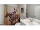 Unique bathroom featuring a cowboy-themed shower curtain and neutral fixtures at 7435 Ansley Park Way, Cumming, GA 30028