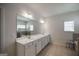 Bright bathroom featuring dual vanity, tile flooring, and a glass-enclosed shower, offering modern elegance at 7435 Ansley Park Way, Cumming, GA 30028